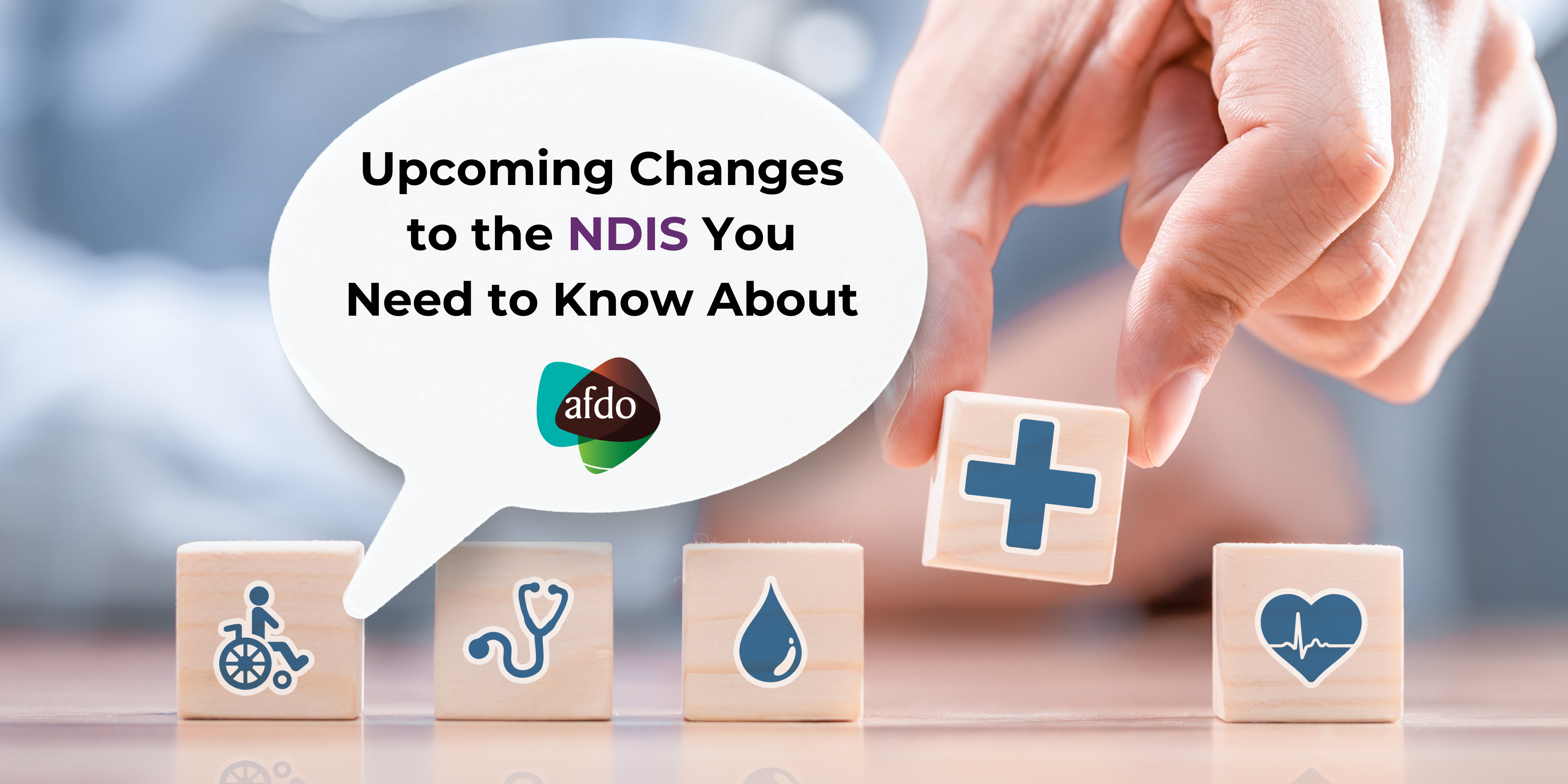 Image shows various wooden blocks with health-related images, with one being picked up by a large hand. Text reads 'Upcoming changes to the NDIS you need to know about'.